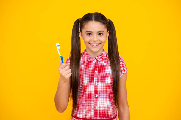 Dental care, hygiene and child. Teenage girl with toothbrush brushing teeth. Happy teenager, positive and smiling emotions of teen girl - Fotó, kép