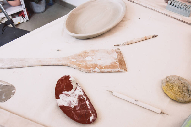 Pottery tools set on a ceramics studio background, in artisan craftsman classes workshop - Photo, Image