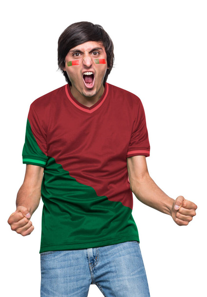Soccer fan man with jersey and face painted with the flag of the Portugal team screaming with emotion on white background. - Foto, Imagem