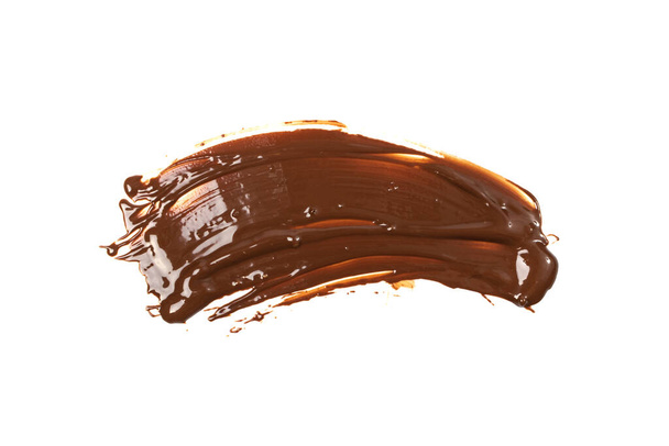 Gesmolten chocolade textuur achtergrond geïsoleerd. Smeared Liquid Chocolate Cream Pattern, Cacao siroop Mockup met plaats voor tekst, Kopieer ruimte - Foto, afbeelding