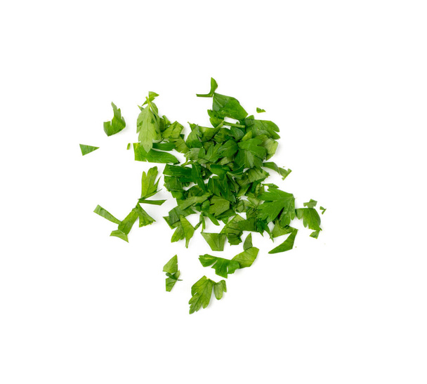 Fresh chopped parsley isolated. Sliced cilantro leaves, raw garden parsley, chervil, corriender pieces on white background top view - Foto, Imagem