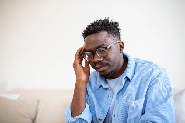 Young frustrated man suffering from chronic daily headaches, treatment online, appointing to a medical consultation, electromagnetic radiation, sick pay - Fotó, kép