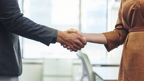 Another day, another deal. two unrecognizable businesspeople shaking hands in their office - Photo, Image