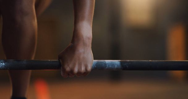 Grip onto your goals with your bare hands. Closeup shot of an unrecognisable woman getting ready to lift a barbell in a gym - Фото, изображение