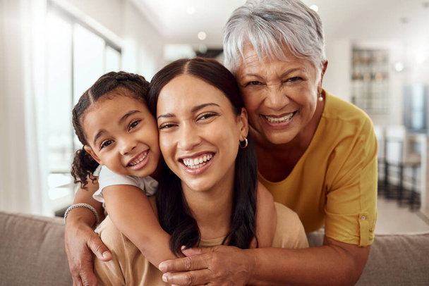 Child, mother and grandmother portrait while at home on sofa with smile, love and support sharing hug for generation of senior, woman and child. Portrait of brazil girls happy on mothers day together. - Foto, Imagem