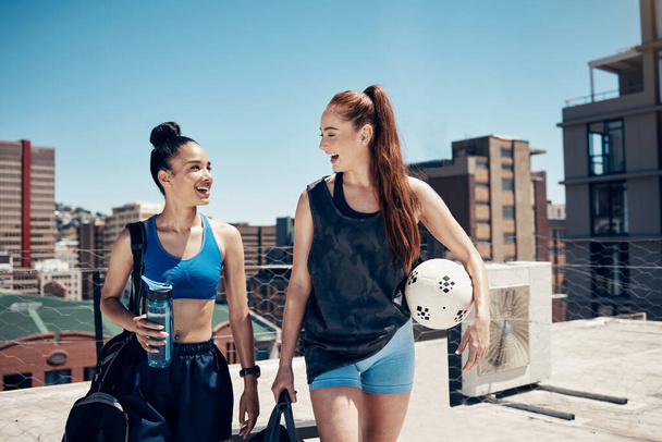 Women go to sports training with ball, rooftop city sports in Colombia or walking to football game. Friends exercise together, happy to exercise in urban lifestyle or healthy soccer coach workout. - Foto, Imagem