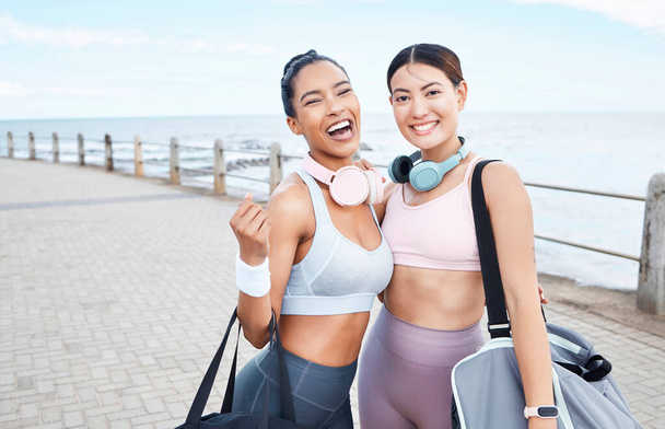 Women after beach workout, portrait of friends with healthy exercise lifestyle in summer and Monaco sidewalk with sports bag. Happy young girls, body fitness by sea together and outdoor gym training. - Photo, Image