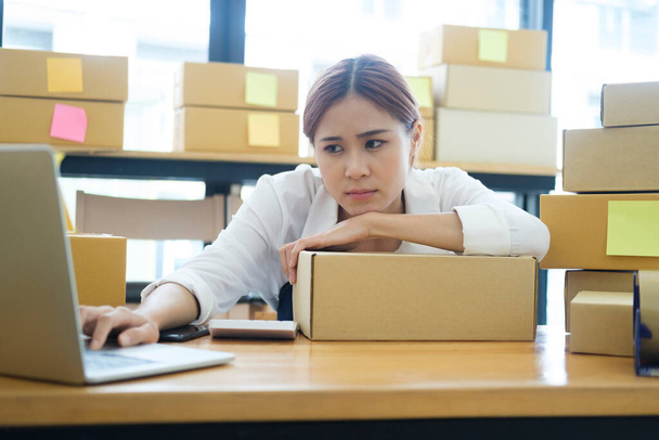 Asian female online business owner feeling disappointed and frustrated after checking online sales with low order. Female entrepreneur getting tired for being unsuccesful at her online business. - Fotoğraf, Görsel
