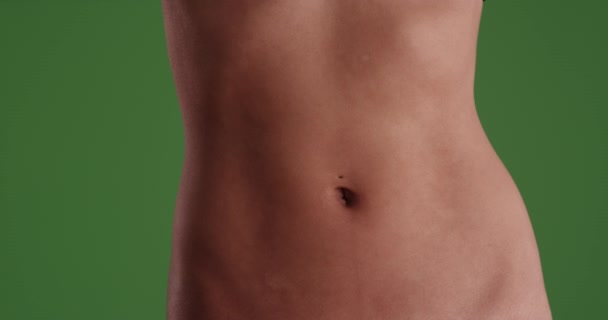 Isolated Closeup of Asian woman's flat belly on green screen. On green screen for keying or compositing. - Footage, Video