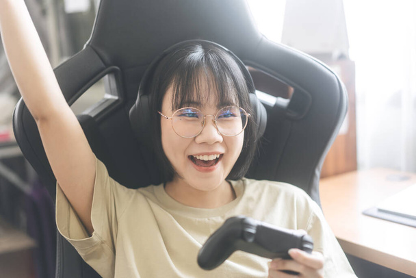 Nerd estilo joven adulto asiático gamer mujer usar gafas jugar un juego en línea. Competición por el estado de ánimo victoria. Gente ocio estilo de vida en casa - Foto, Imagen