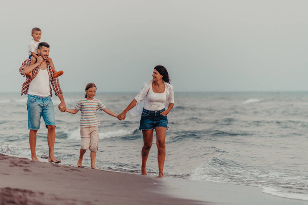 Family gatherings and socializing on the beach at sunset. The family walks along the sandy beach. Selective focus. High quality photo - Zdjęcie, obraz