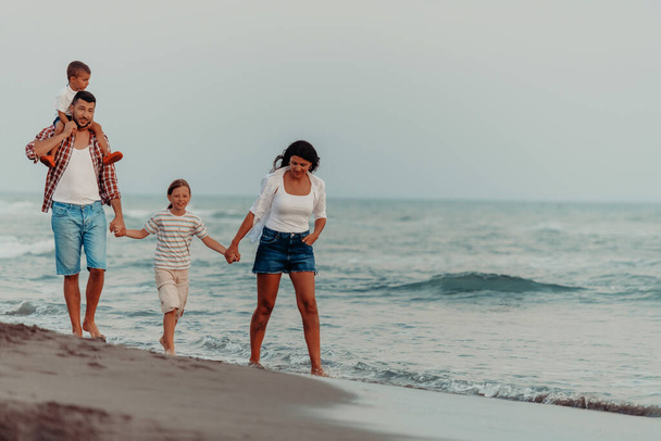 Family gatherings and socializing on the beach at sunset. The family walks along the sandy beach. Selective focus. High quality photo - Zdjęcie, obraz