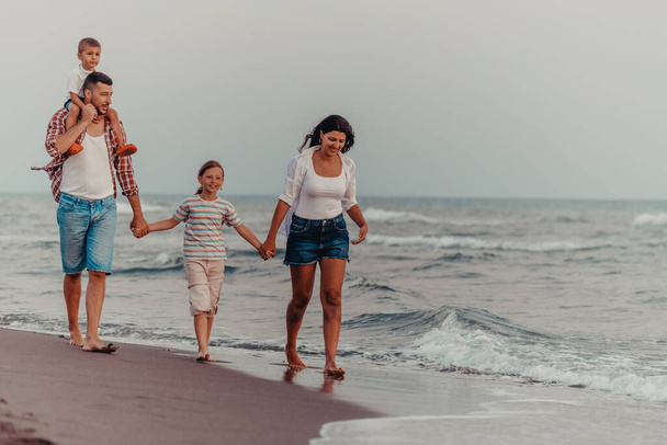 Family gatherings and socializing on the beach at sunset. The family walks along the sandy beach. Selective focus. High quality photo - Foto, Imagen