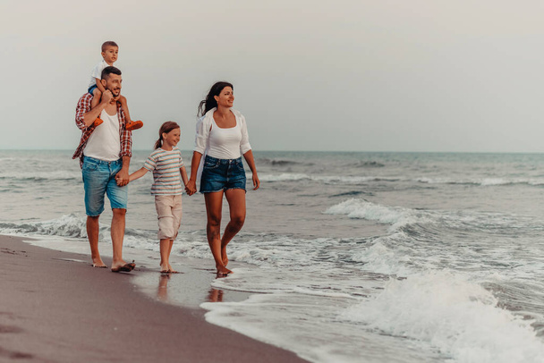 Family gatherings and socializing on the beach at sunset. The family walks along the sandy beach. Selective focus. High quality photo - Fotoğraf, Görsel