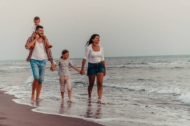 Family gatherings and socializing on the beach at sunset. The family walks along the sandy beach. Selective focus. High quality photo - Foto, Imagen