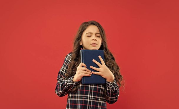 sleepy child hold book on red background, study. - Фото, изображение