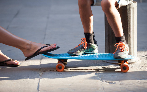 feet of man and woman on skateboard - Photo, Image