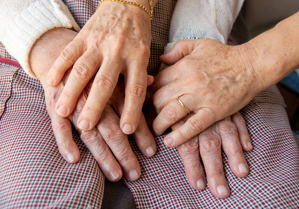hands of the elderly person and young person - Φωτογραφία, εικόνα