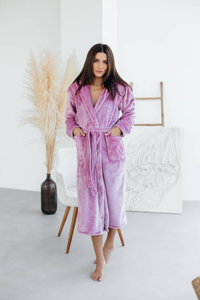 Young healthy serene woman girl relaxing in bathrobe and spa towel after having bath shower at home. Beauty treatment, rest and body care procedures. High quality photo - Photo, Image