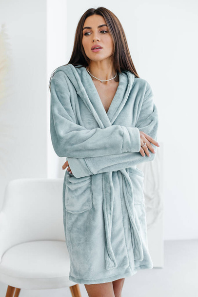 Young healthy serene woman girl relaxing in bathrobe and spa towel after having bath shower at home. Beauty treatment, rest and body care procedures. High quality photo - Фото, зображення
