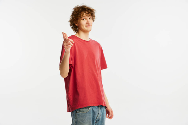 Make your personal choice. Young man with happy facial expression looking at camera isolated over white background. Human rights, emotions, youth, sales, ad. Model, actor wearing red t-shirt - Fotoğraf, Görsel
