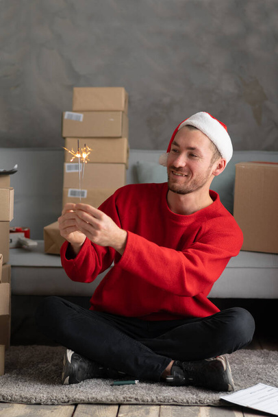 start up small business owner taking sparklers at workplace in home. man seller prepare parcel box of product for deliver to customer. Online selling, e-commerce, shipping concept - Photo, Image