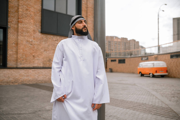 Orient culture. Middle eastern bearded man in traditional white clothing - Photo, Image