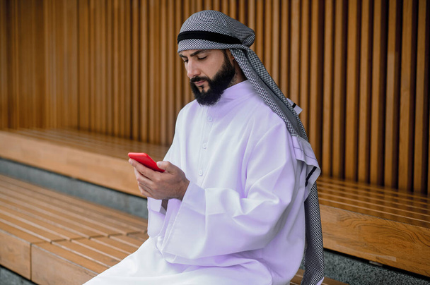 Chatting. Middle eastern young man typing a message - Photo, Image