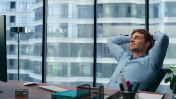 Confident director having break on panoramic office chair. Thinking man stretching arms after work in luxury city view interior. Successful businessman relaxing enjoying at comfortable workplace - Footage, Video