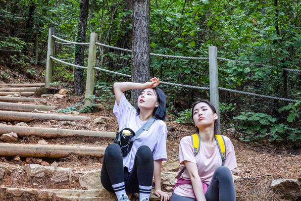 korean young women hiking and plogging_tired - Photo, Image