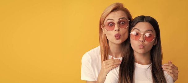 Mother and daughter child banner, copy space, isolated background. happy family portrait of woman mother and kid in glasses blow kiss, togetherness - Zdjęcie, obraz