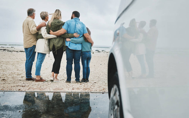 Travel, love and big family hug at ocean for bonding experience on road trip in Australia. Adventure, beach and drive for holiday break sightseeing with parents, grandparents and child - Zdjęcie, obraz