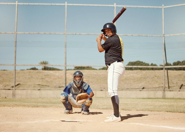 Baseball, pitcher and man with a bat on pitch playing a match or sport training as a team. Fitness, sports and men athletes practicing pitching and batting before a softball game on an outdoor field - Photo, Image