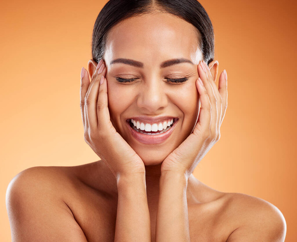 Skincare, smile and woman excited about face wellness against an orange mockup studio background. Happy, relax and beauty model with happiness for facial cosmetics, skin health and dermatology. - Photo, Image