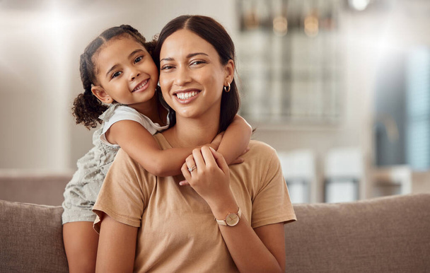Black family, hug and portrait of child with mother, mom or mama bond, relax and enjoy quality time together. Love, happy family and woman with kid girl smile, care or lounge on home living room sofa. - 写真・画像