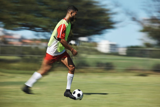 Soccer, sports and man athlete in a football game on sport field running fast and kick in nature. Fitness, training and health exercise of a workout match run with a player energy and motivation. - Foto, imagen