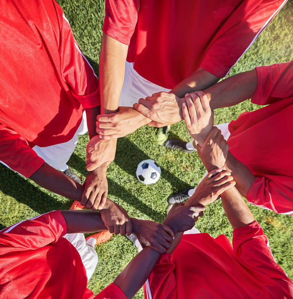 Soccer, hands and team sport with support before match, game or training with ball in circle group of men. Top of football field, pitch and grass with people showing trust, motivation and teamwork. - Foto, imagen