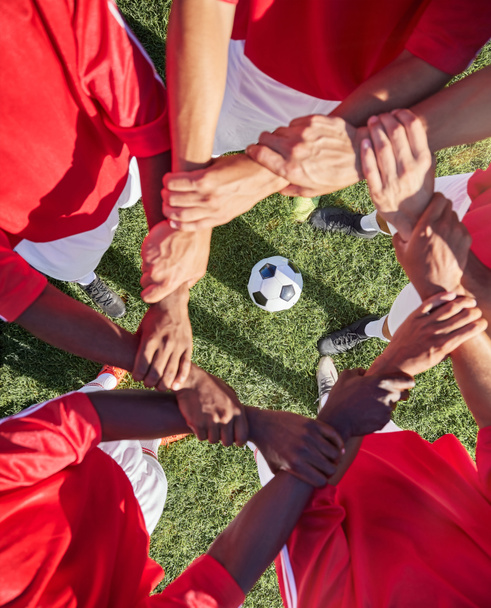 Support, football and hands of team for sports on grass field for training, teamwork or collaboration. Fitness, workout or exercise with people in circle and soccer ball for goals, growth and friends. - Foto, Imagen