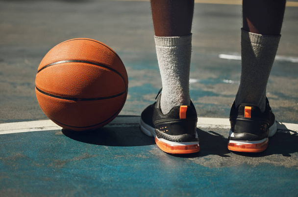 Basketball, basketball player and athlete legs close up on basketball court outdoors fitness training workout. Young African American man, sports exercise and healthy lifestyle motivation outside. - Foto, afbeelding