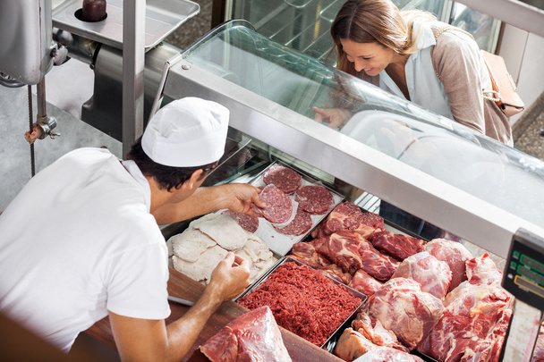 Butcher Showing Meat To Customer At Butchery - Zdjęcie, obraz