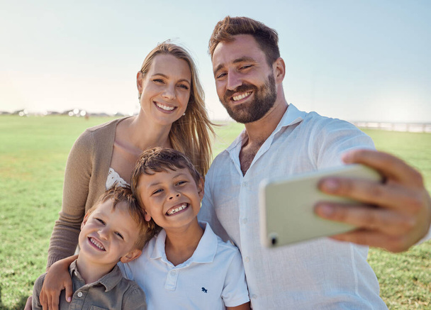 Nature, selfie and phone with happy family social media picture on a holiday together in outdoor green garden. Happy, smile and parents smile, photo and love bonding with children outside in a park. - Fotoğraf, Görsel