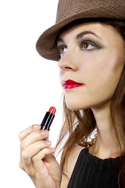 Girl applying red lipstick - Fotó, kép