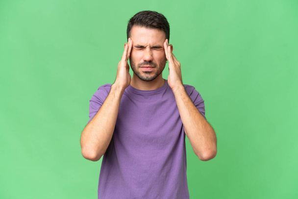 Young handsome caucasian man over isolated background with headache - 写真・画像