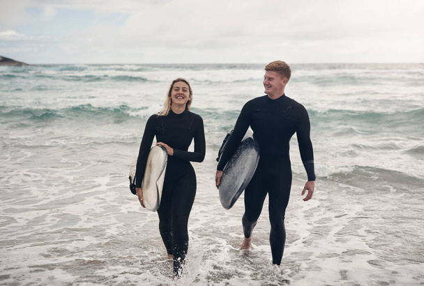 Ive never had so much fun. a young couple out at the beach with their surfboards - Fotó, kép