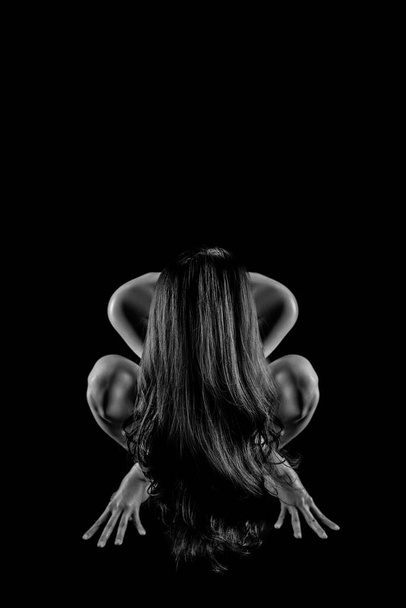 halloween black and white background of scary woman squating down with long hair covered face. Concept of evil creepy witch or demon for halloween night - Foto, Imagen