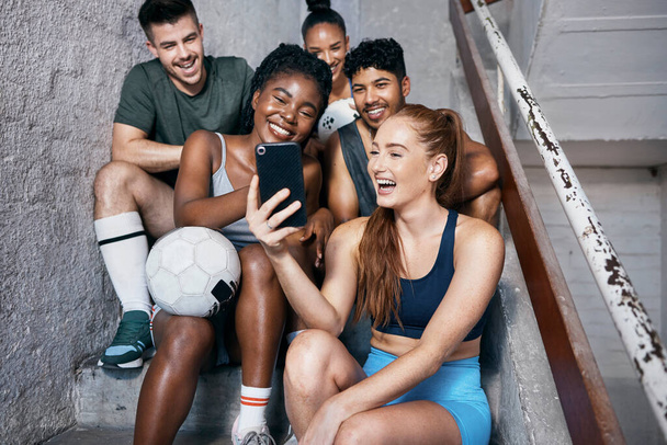 Selfie, smartphone and soccer people for sports social networking team, 5g international communication or connection on stairs. Diversity athlete football friends using phone for a social media post. - Фото, изображение