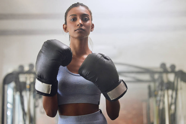 Dont underestimate what I can do. a young woman going through a boxing workout routine in a gym - Photo, image