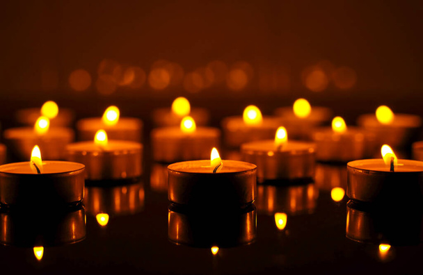 Burning candles in night. Festive Christmas background - Фото, изображение