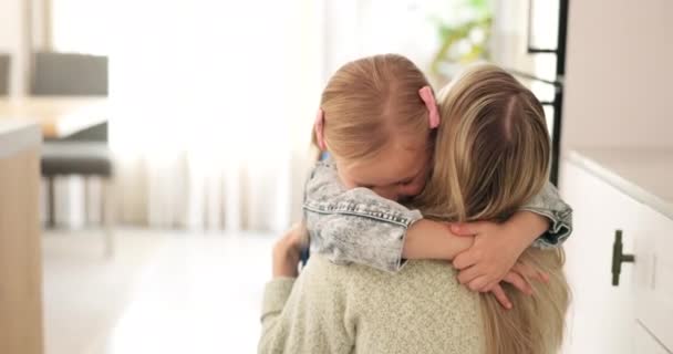 Hug, mother and child with love, care and smile to celebrate mothers day in their house. Young girl hugging her mom for affection, happiness and peace in the living room of their family home. - Footage, Video