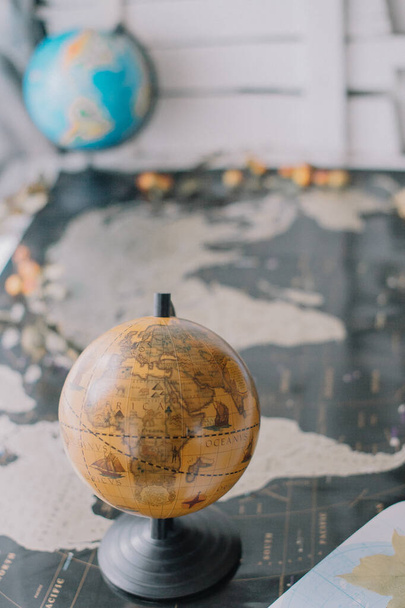Globo marrón en el mapa del mundo con fondo borroso. - Foto, Imagen